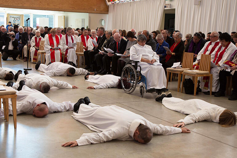 A solemn moment of surrender. The Rev Irene Nelson had had an accident the day before - hence the chair.