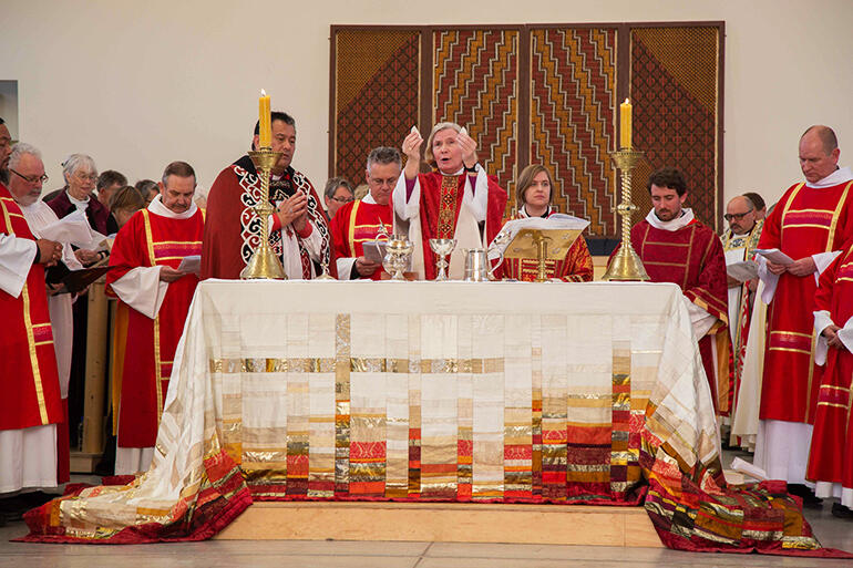 Bishop Victoria breaks the bread. Bishop Victoria breaks the bread.