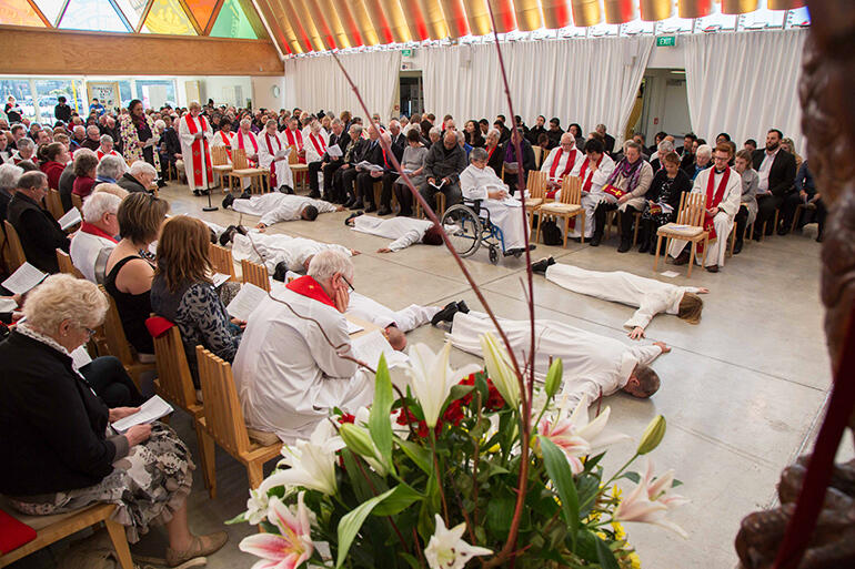 The candidates prostrate themselves as a sign of their submission to God.