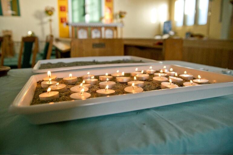 Lighting the darkness: the 29 lit candles at Holy Trinity, Greymouth that signify love for Pike River's perished coalminers. Stewart Nimmo Photography