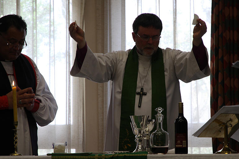 Silhouette of a sacrifice celebrated: Archbishop Philip Richardson presided at the Eucharist. Silhouette of a sacrifice celebrated: Archbishop Philip Richardson presided at the Eucharist.