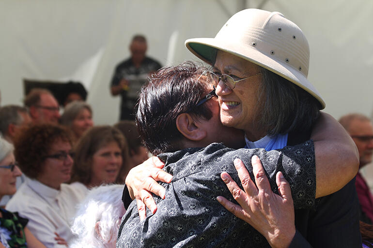 That's Rev Iritana Hankins in the pith helmet - she's the president of The Mothers' Union - greeting Winnie Douglas, who is a student at St John's.