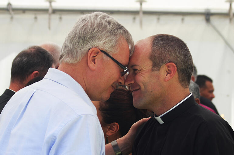 That's Stephen Jacobi, the Chairman of the St John's College Trust - greeting Rev Jayson Rhodes, the new college communications lecturer.