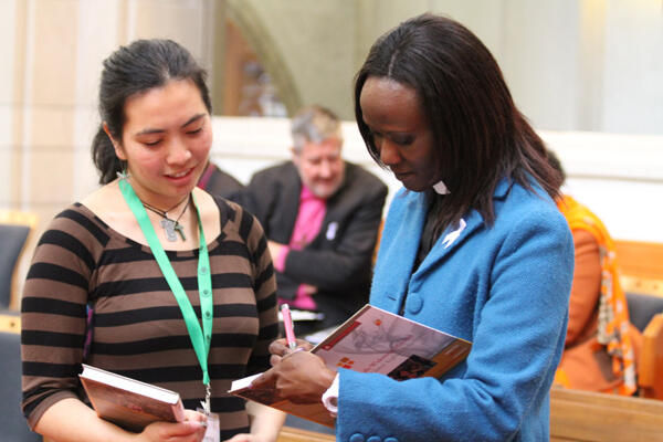 Irene Ayallo from Kenya signs the new mission road map for Kaz Yung.