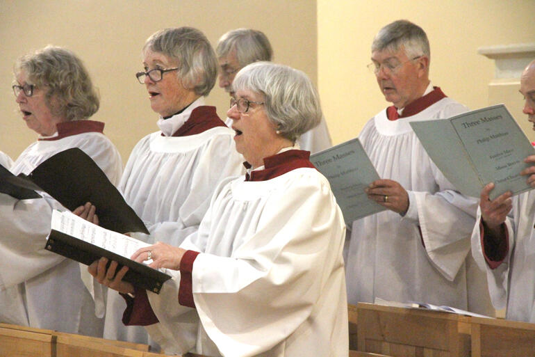 Choir members from St Peter's Waikato Cathedral sing the mass responses during the hākari tapu. Choir members from St Peter's Waikato Cathedral sing the mass responses during the hākari tapu.