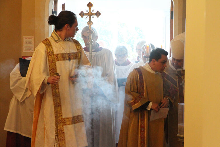 Clergy and servers gather at the Cathedral door surrounded by incense before the mass. Clergy and servers gather at the Cathedral door surrounded by incense before the mass.