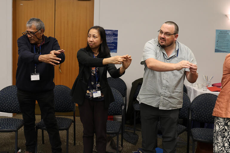 Clive Moeke, Rachielyn Paaka and Toby Walton learn how to sign a waiata.