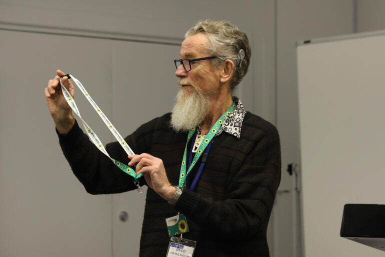 David Loving-Molloy shows off his Hidden Disability Sunflower Scheme lanyards.