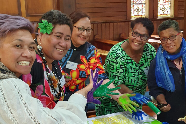 Hui members display the results of their fabric painting on the theme 'Many Hands lighten the load'. Img: C.Parr.