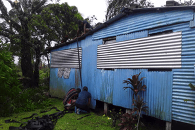 Diocese of Polynesia volunteers secure storm shutters. Donations to Anglican Missions' Cyclone Yasa appeal will aid recovery in Vanua Levu. 