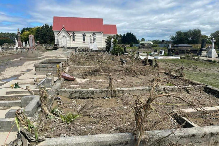 Embattled looking graves emerge after the raging Ngaruroro River drains away from St John's Omahu urupa.