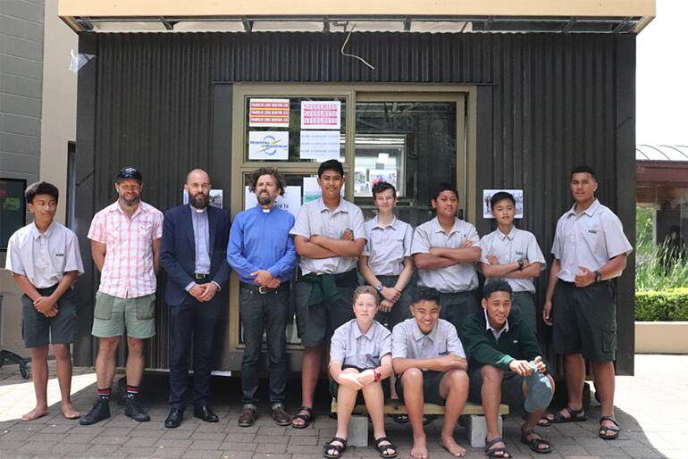 Dilworth Rural Campus Year 9 students line up outside the sleepout they've built with teacher Dan Fieten, Rev Greg Worboys and Rev Joel Carpenter.