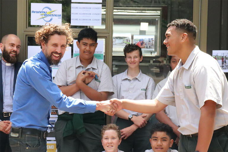 Rev Joel Carpenter and Dilworth student Josh Futi shake hands on the sleepout he and his Year 9 classmates built for a local family in need.