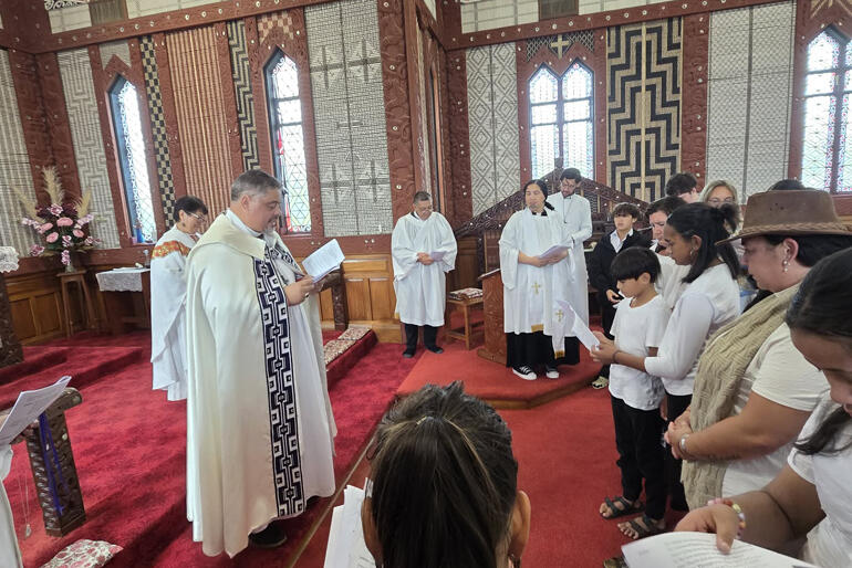 Archbishop Don Tamihere greets a youngster amongst the 11 people baptised and 21 confirmed at St Mary's Tikitiki on Easter Day 2026.
