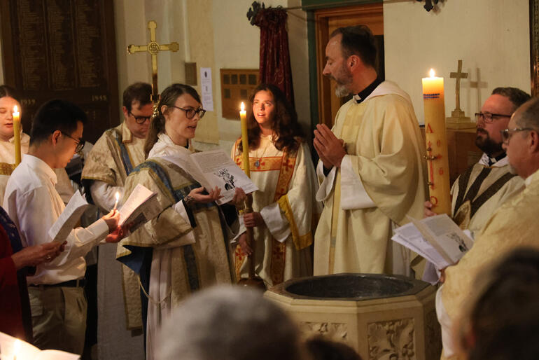 Members of Dunedin North Anglican parish gather round the font to sing the litany of saints before an Easter Vigil baptism.