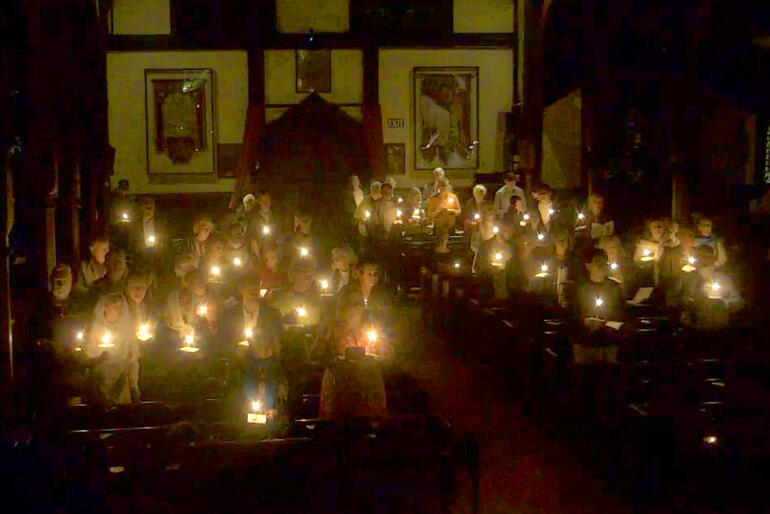 Saint Michael and All Angels' Christchurch congregation hold their candles aloft during the Easter Vigil on Holy Saturday 2026.