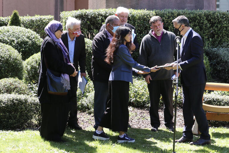 Abp Philip Richardson joins NZ religious leaders as Mandira Shailaj presents the COP26 statement to Hon James Shaw. Photo: Paddy Payne