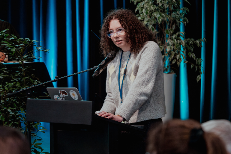 Auckland diocesan delegate Jessica Hughes presents Motion 9 on 50th celebrations of women's ordination. Auckland diocesan delegate Jessica Hughes presents Motion 9 on 50th celebrations of women's ordination.