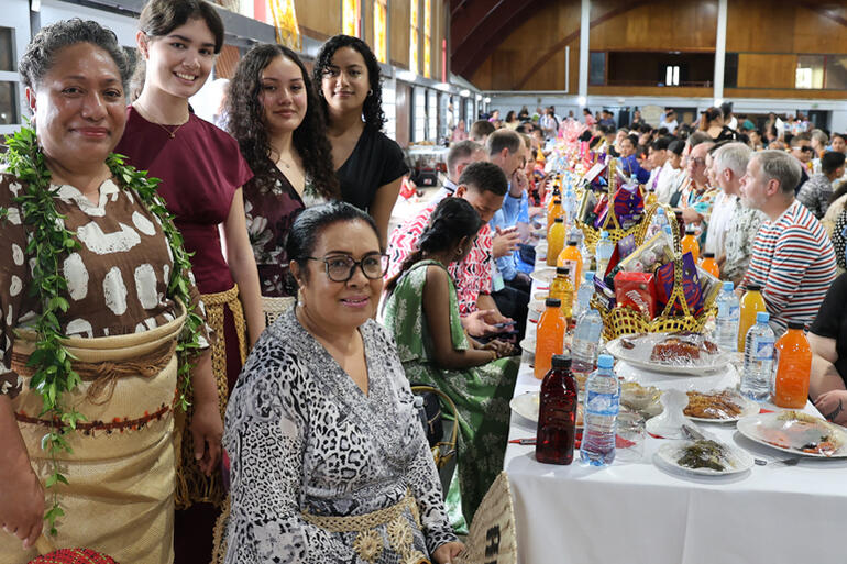Ana Madden (seated) and her crew from St Paul's Nuku'alofa show off the banquet table they have prepared.
