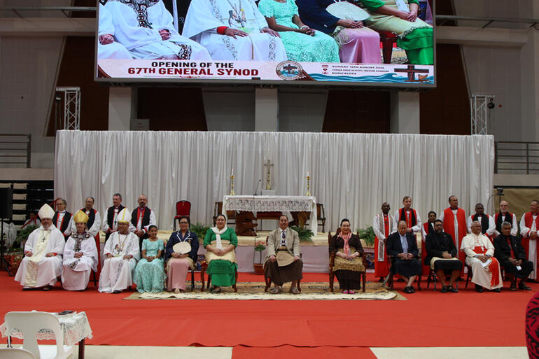 Archbishops, bishops and delegates line up for a picture with members of the Royal House of Tupou.