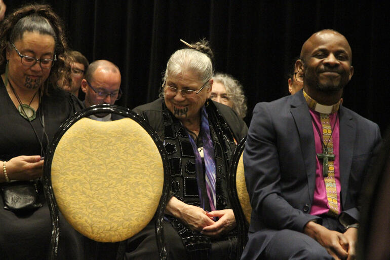 Te Waipounamu delegate Susan Wallace, kaikaranga Jane du Feu and Bishop Steve Maina share a laugh during the whaikōrero. 