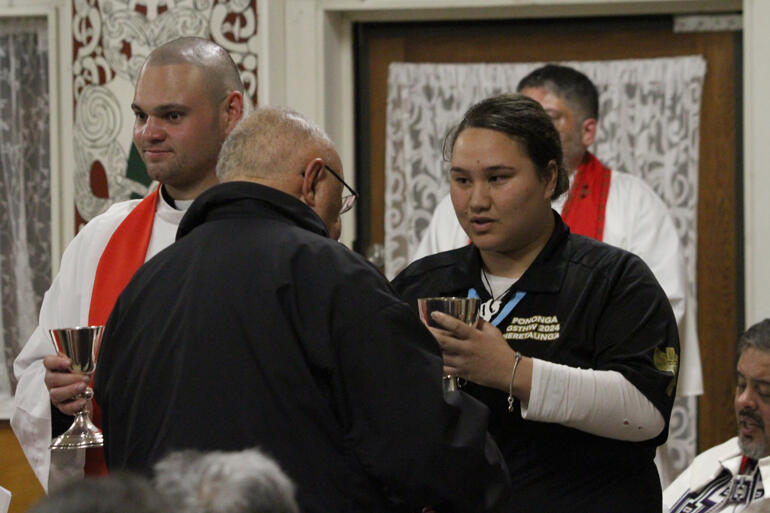 L-R: Rev Zhane Tahau Whelan and Haley Ruru serve communion during the Opening Eucharist of General Synod '24. L-R: Rev Zhane Tahau Whelan and Haley Ruru serve communion during the Opening Eucharist of General Synod '24.