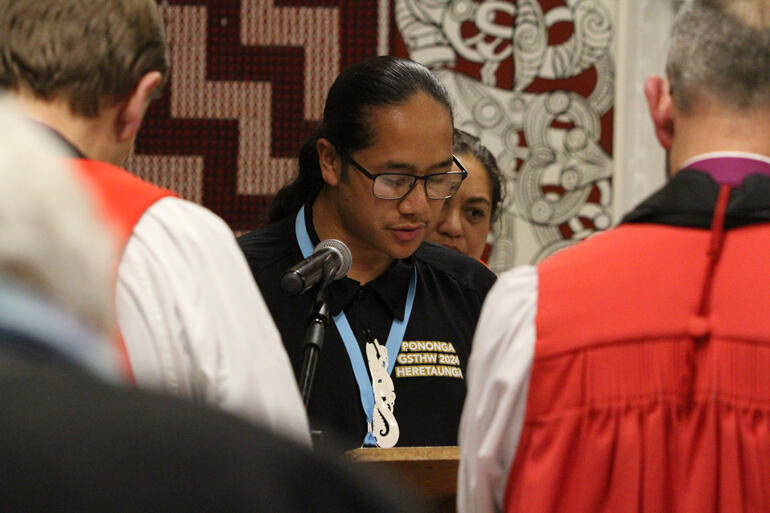 Pononga (Synod youth steward) Apache Hānara reads scripture during worship in Kahukuranui. Pononga (Synod youth steward) Apache Hānara reads scripture during worship in Kahukuranui.
