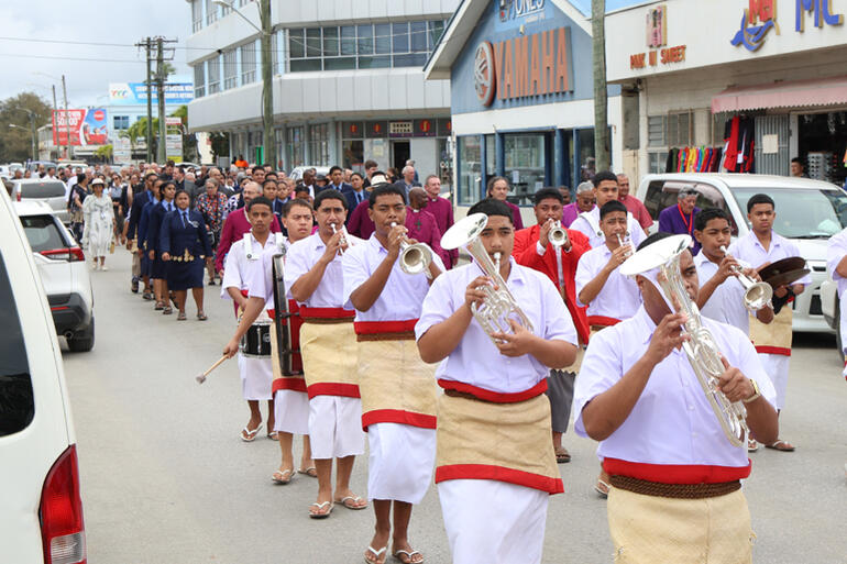 St Andrew's High School band and prefects join the procession to the King's Palace.