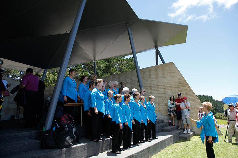 A choir sings carols in Rore Kahu, the Rangihou Heritage Park interpretive centre.