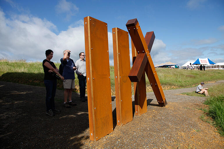 Visitors read the inscriptions on one of the new 'way stations' on the walkway down to Oihi Beach and the Marsden Cross. Visitors read the inscriptions on one of the new 'way stations' on the walkway down to Oihi Beach and the Marsden Cross.