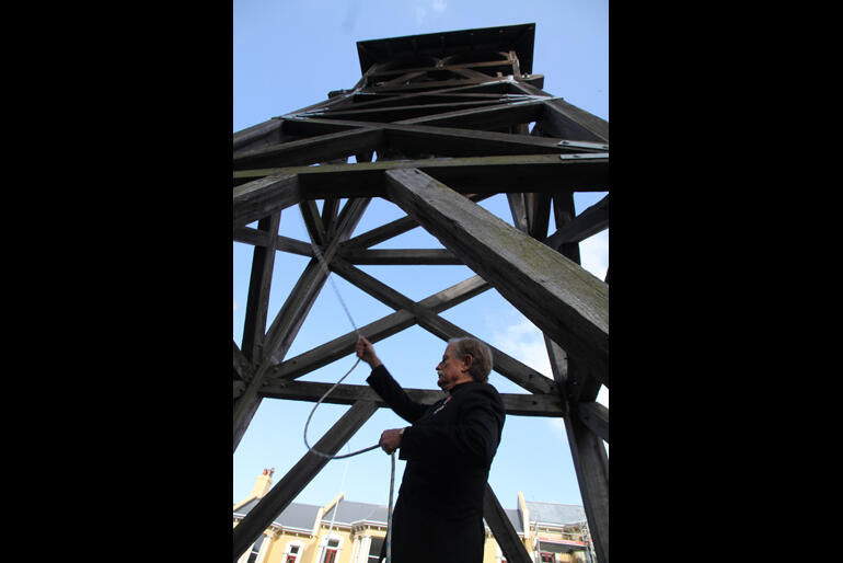 Rev Bruce Aitken tolls the bell at St Paul's Cathedral Dunedin at noon on 9 September 2022 to mark Queen Elizabeth II's passing.