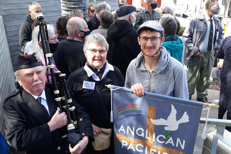 Anglican Pacifist Fellowship's Ven Indrea Alexander and Ollie Alexander stand with Pipe Major Bill Swift who piped open the event. Anglican Pacifist Fellowship's Ven Indrea Alexander and Ollie Alexander stand with Pipe Major Bill Swift who piped open the event.
