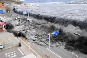 The tsunami crashes over a street in Miyako City in north-eastern Japan. Photo: Reuters