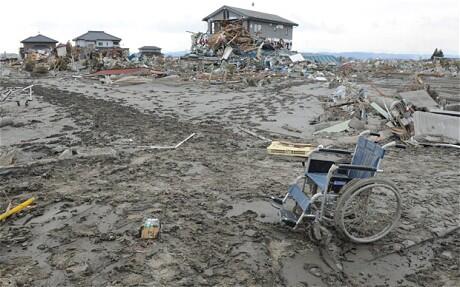 A wheelchair sits forlorn amid the desolation of a town in northern Japan. A wheelchair sits forlorn amid the desolation of a town in northern Japan.