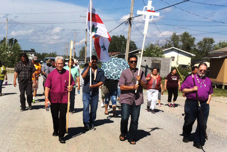 Bishop Ngarahu Katene and Robert Kereopa walk with Bishop Mark MacDonald and people of the Indigenous Spiritual Ministry of Mishamikoweesh. Bishop Ngarahu Katene and Robert Kereopa walk with Bishop Mark MacDonald and people of the Indigenous Spiritual Ministry of Mishamikoweesh.