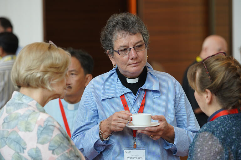 Archdeacon Wendy Scott connects with fellow ACC delegates, earlier she presided at the Pacific-led Eucharist for the ACC.