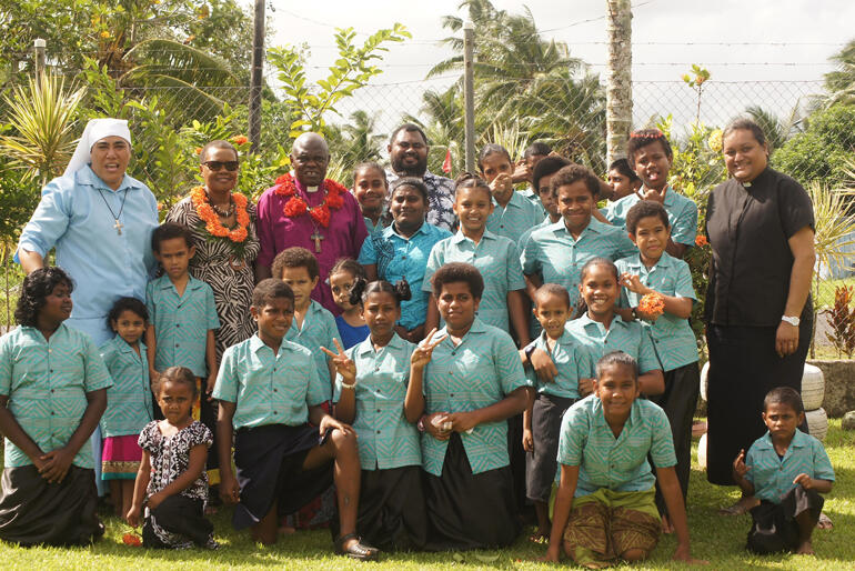 Sister Kalolaine Tuineau and the children of St Christopher's Home take a picture with their visitors.