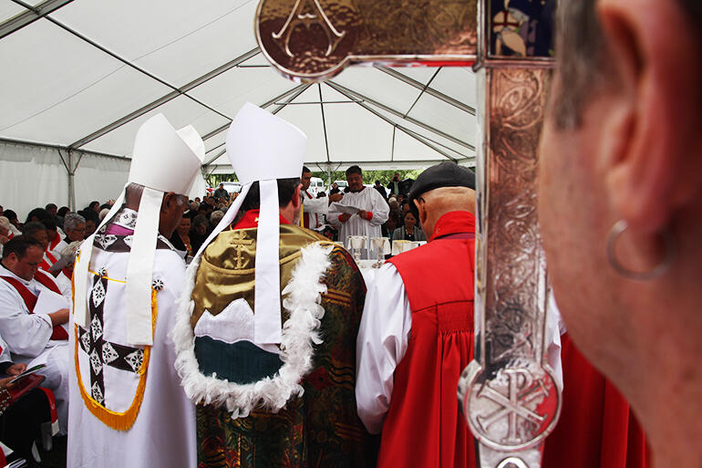 Bishop-elect Don makes his commitments - with the Primatial Cross in the foreground.