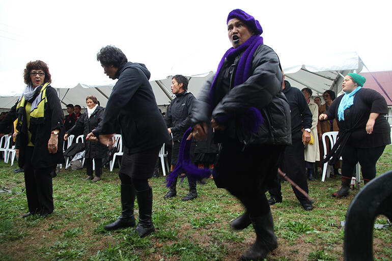 The woman out front is Hinetu Dell. Ngati Porou women wear purple to important events. The woman out front is Hinetu Dell. Ngati Porou women wear purple to important events.