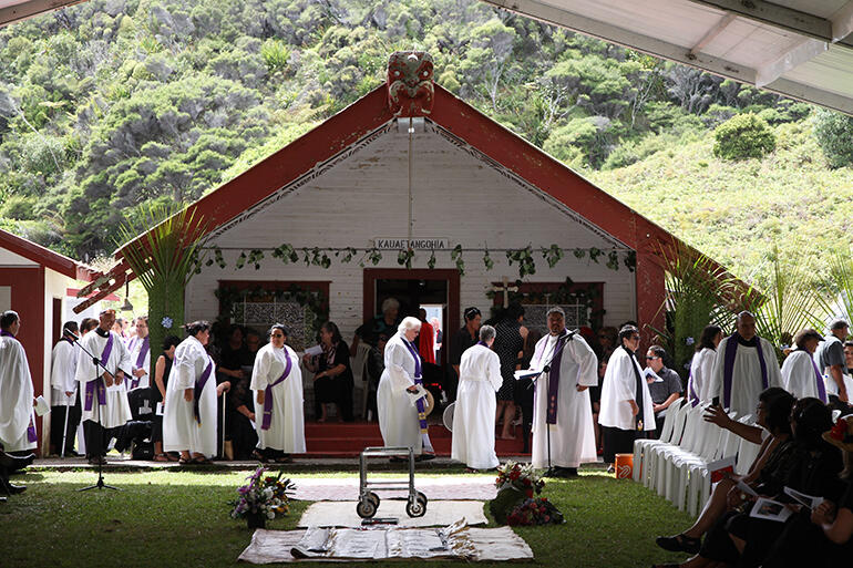 The clergy begin to take their seats.