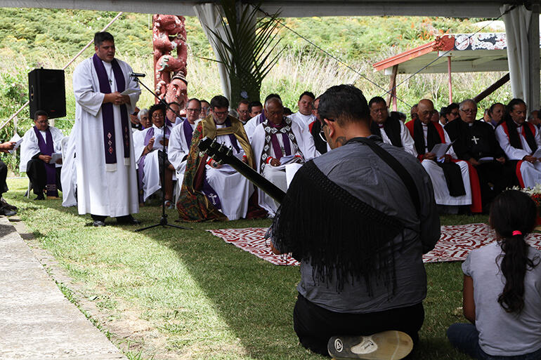 The Rev Michael Tamihere leads in prayer.