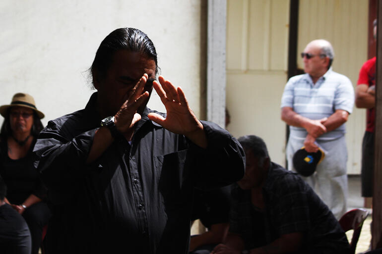 Whanau Apanui kaumatua Dawson Peta praying a Ringatu prayer.