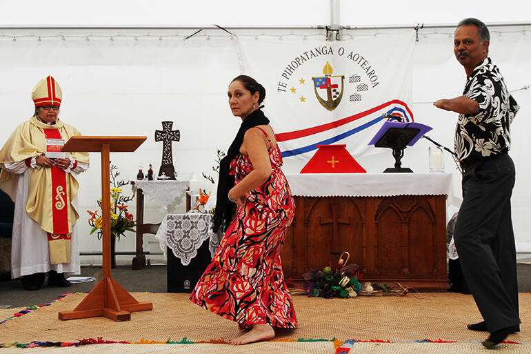 Pi'ilani Hanohano and her husband Edward from Hawaii contribute a hula to the worship. They're watched by Bishop Lydia Mamakwa, of Canada.