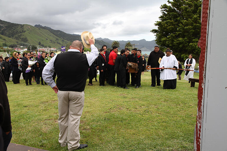 An unexpected pause as the funeral party passes Huiwhenua, the wharenui at Tuatini Marae. An unexpected pause as the funeral party passes Huiwhenua, the wharenui at Tuatini Marae.