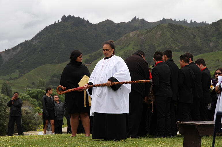 Jackie Chesley-Ingle and the pallbearers pause at Tuatini Marae before processing to the urupa. Jackie Chesley-Ingle and the pallbearers pause at Tuatini Marae before processing to the urupa.