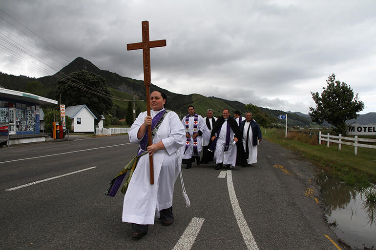 Tessa Tamihere leads the funeral party through Tokomaru Bay.