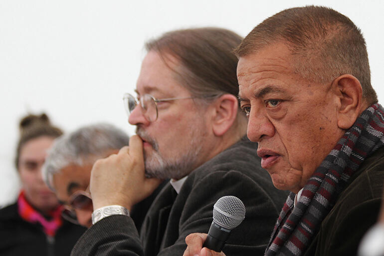 Bishop John Gray speaks, while Bishop Mark McDonald, of Canada, looks pensive.