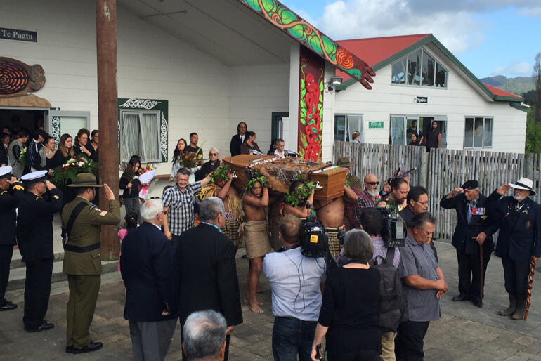 Sir Graham departs Te Paatu marae flanked by an honour guard of servicemen.