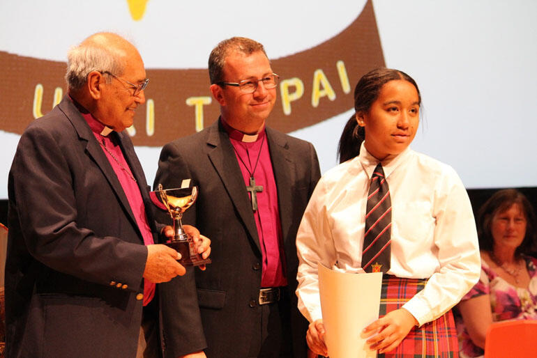 Janelle Williams receives the junior kapa haka prize from Archbishop Brown Turei and Bishop Andrew Hedge. Janelle Williams receives the junior kapa haka prize from Archbishop Brown Turei and Bishop Andrew Hedge.