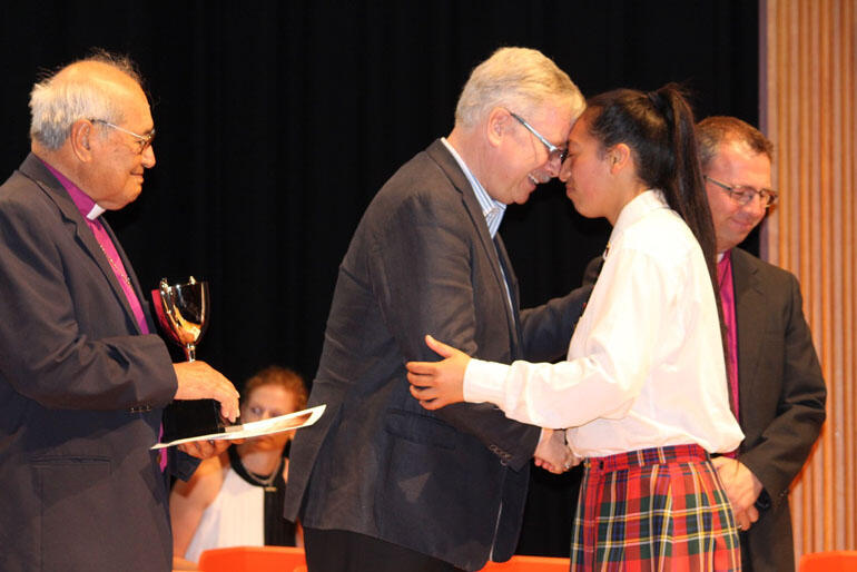 Proxime Accessit, Hinemihi Scott-Baker, is greeted by Te Aute Trust Board chair Stephen Jacobi with Archbishop Brown Turei and Bishop Andrew Hedge.